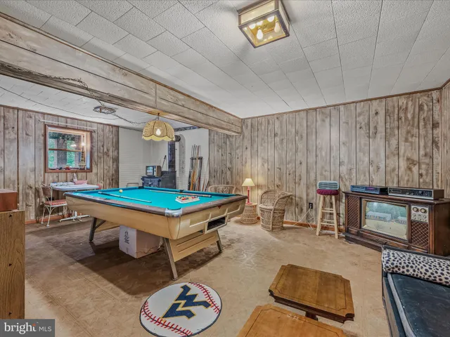 a living room with furniture a ceiling fan and a rug