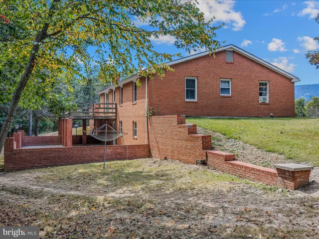 a view of a balcony with wooden floor and fence