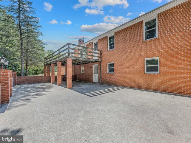 a view of a balcony with wooden floor and fence