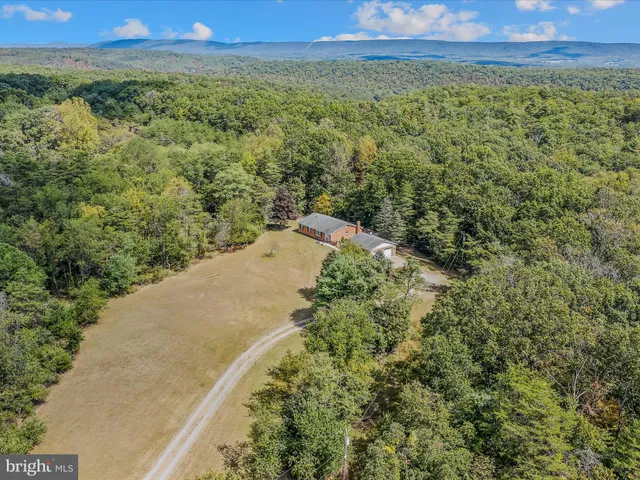 a view of a field with an ocean and mountain view