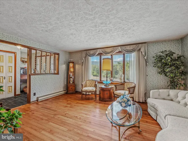 a bedroom with a bed and a refrigerator