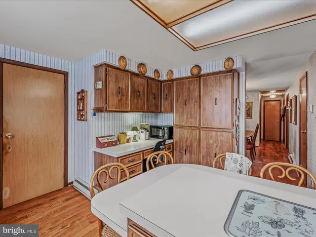 a view of a dining room with furniture a chandelier and wooden floor