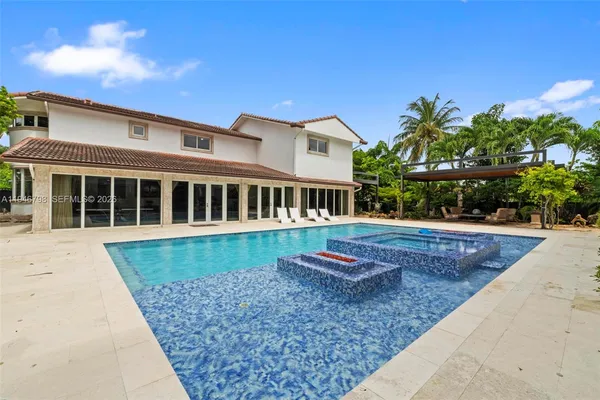 a view of a house with backyard and sitting area