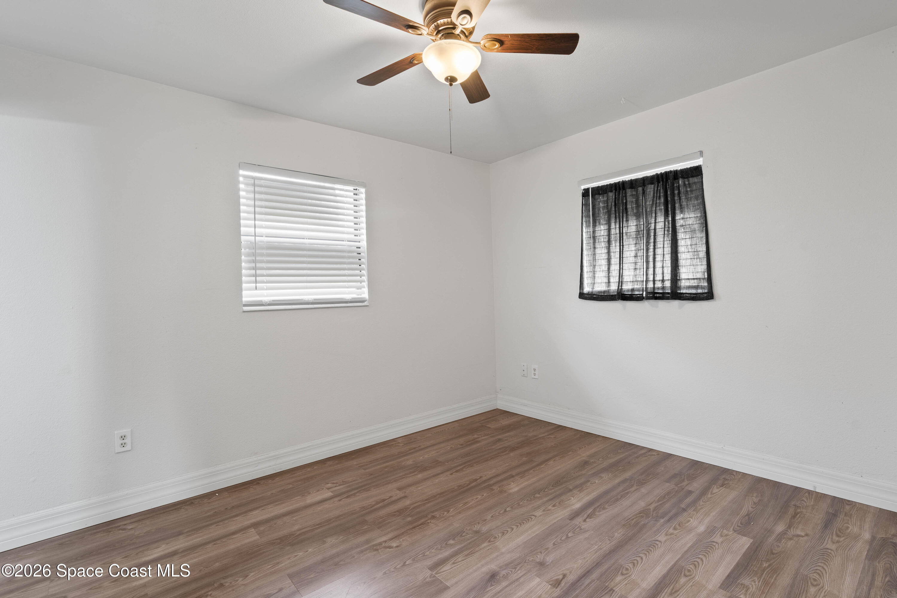 4037 Edwards Street Melbourne, FL 32901 - Photo 14 of 20 a view of an empty room with wooden floor and a window