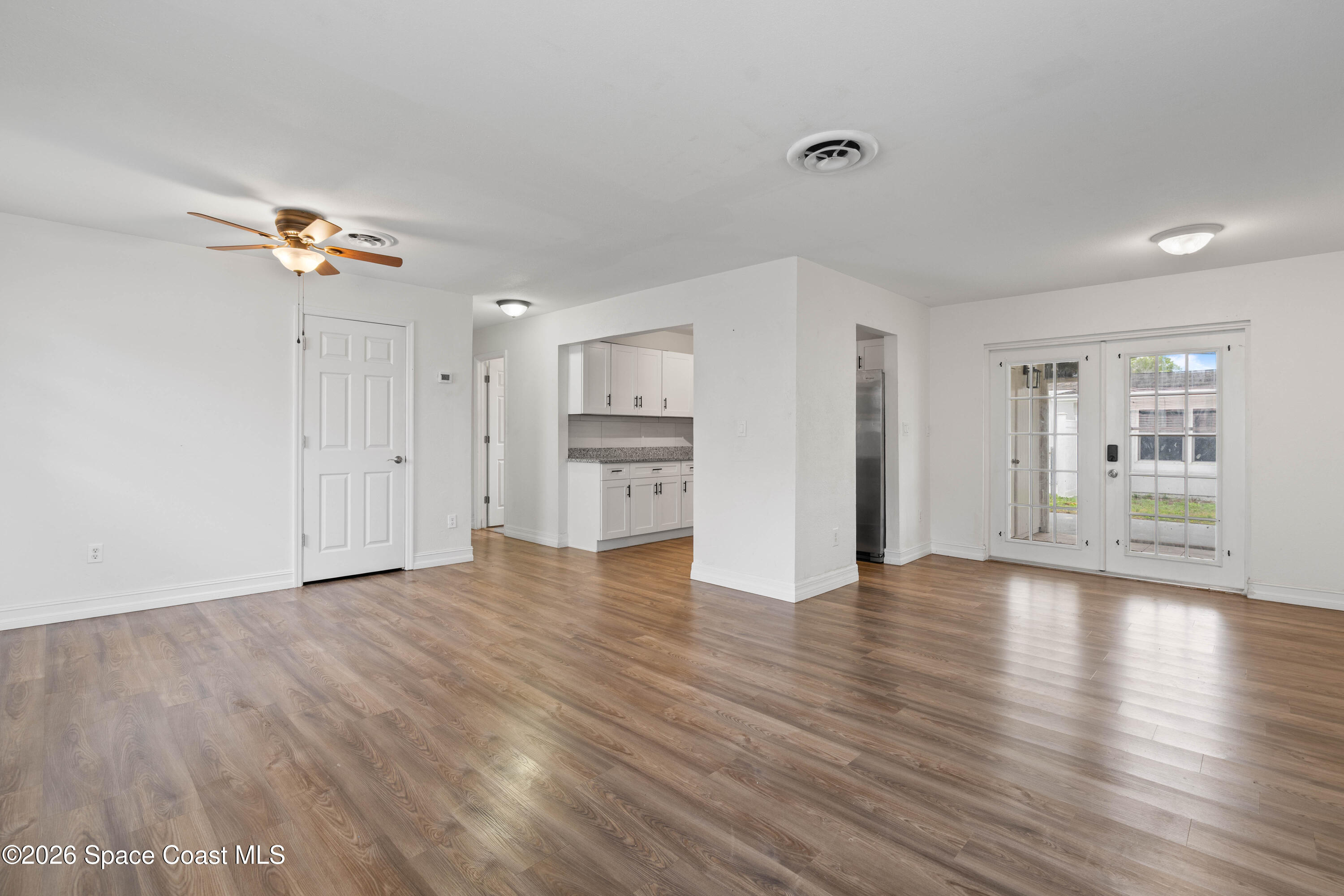 4037 Edwards Street Melbourne, FL 32901 - Photo 6 of 20 a view of empty room with wooden floor and window