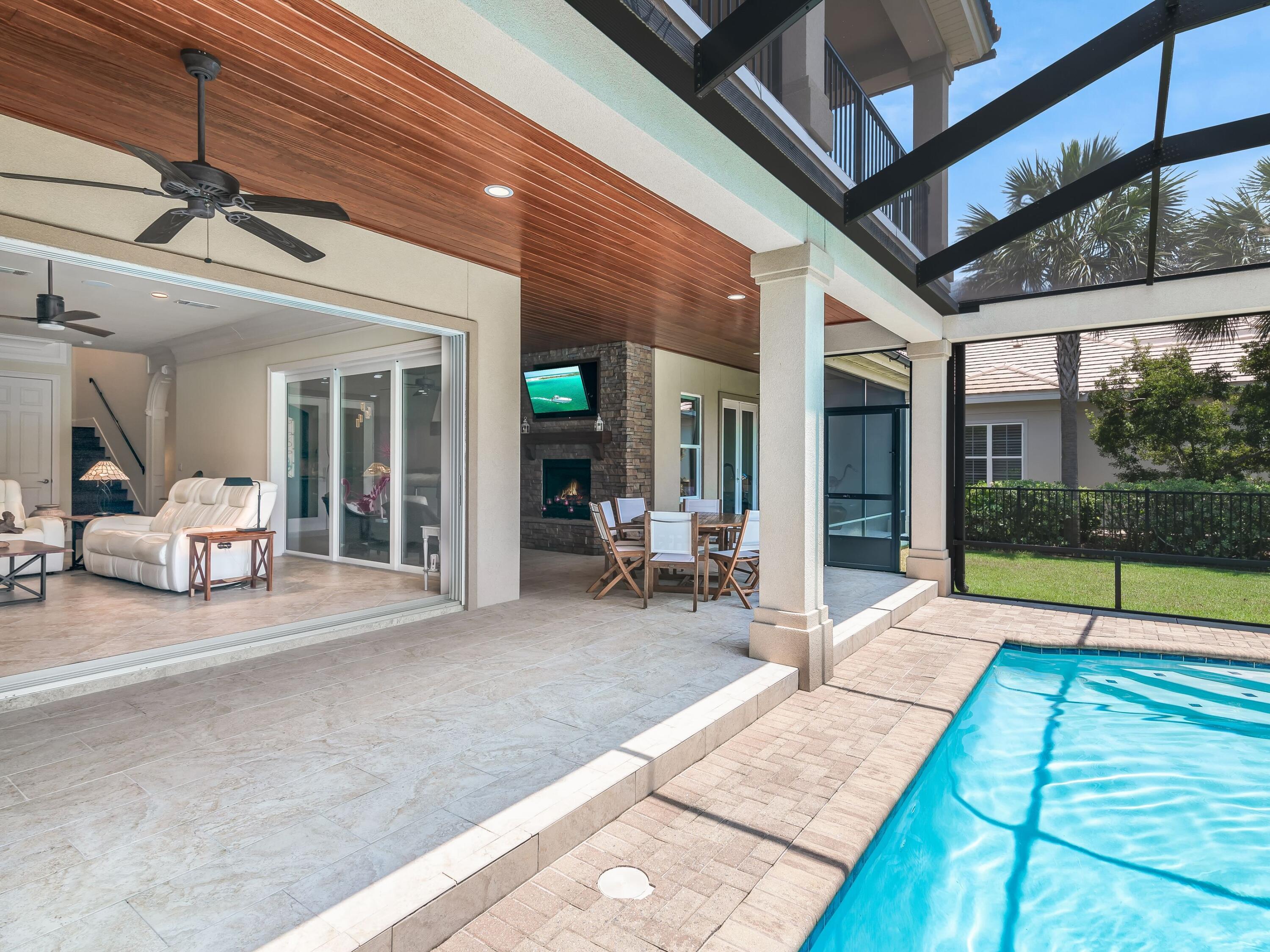 2916 Pine Valley Drive Sandestin, FL 32550 - Photo 16 of 48 a view of a patio with table and chairs and floor to ceiling window