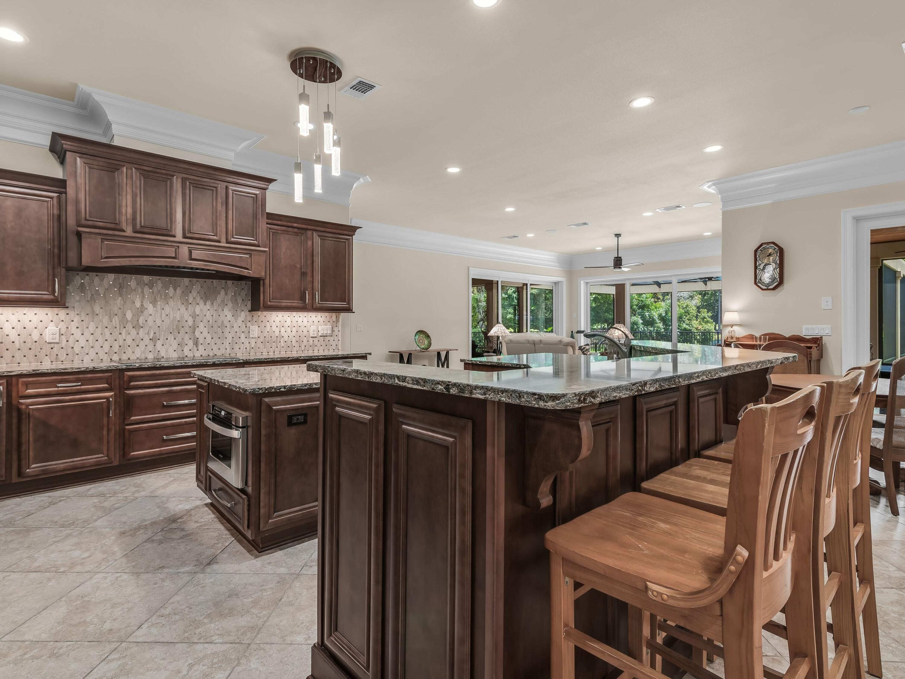 2916 Pine Valley Drive Sandestin, FL 32550 - Photo 26 of 48 a kitchen with stainless steel appliances granite countertop a sink table and chairs