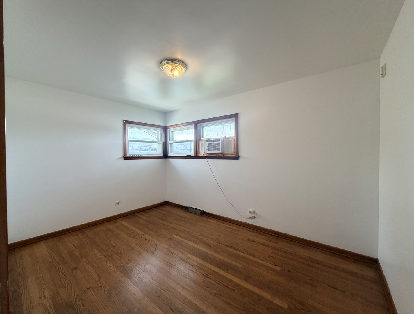 128 North York Road Bensenville, IL 60106 - Photo 18 of 39 an empty room with wooden floor and windows