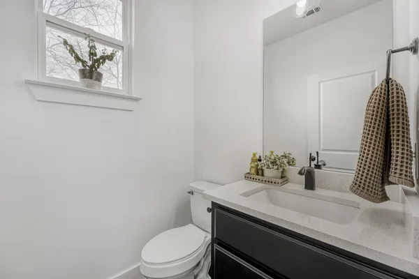 a kitchen with sink refrigerator and cabinets