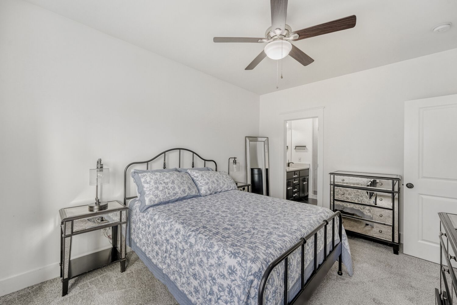 125 Irene Street Elgin, TX 78621 - Photo 14 of 24 Bedroom with light carpet, a ceiling fan, and connected bathroom