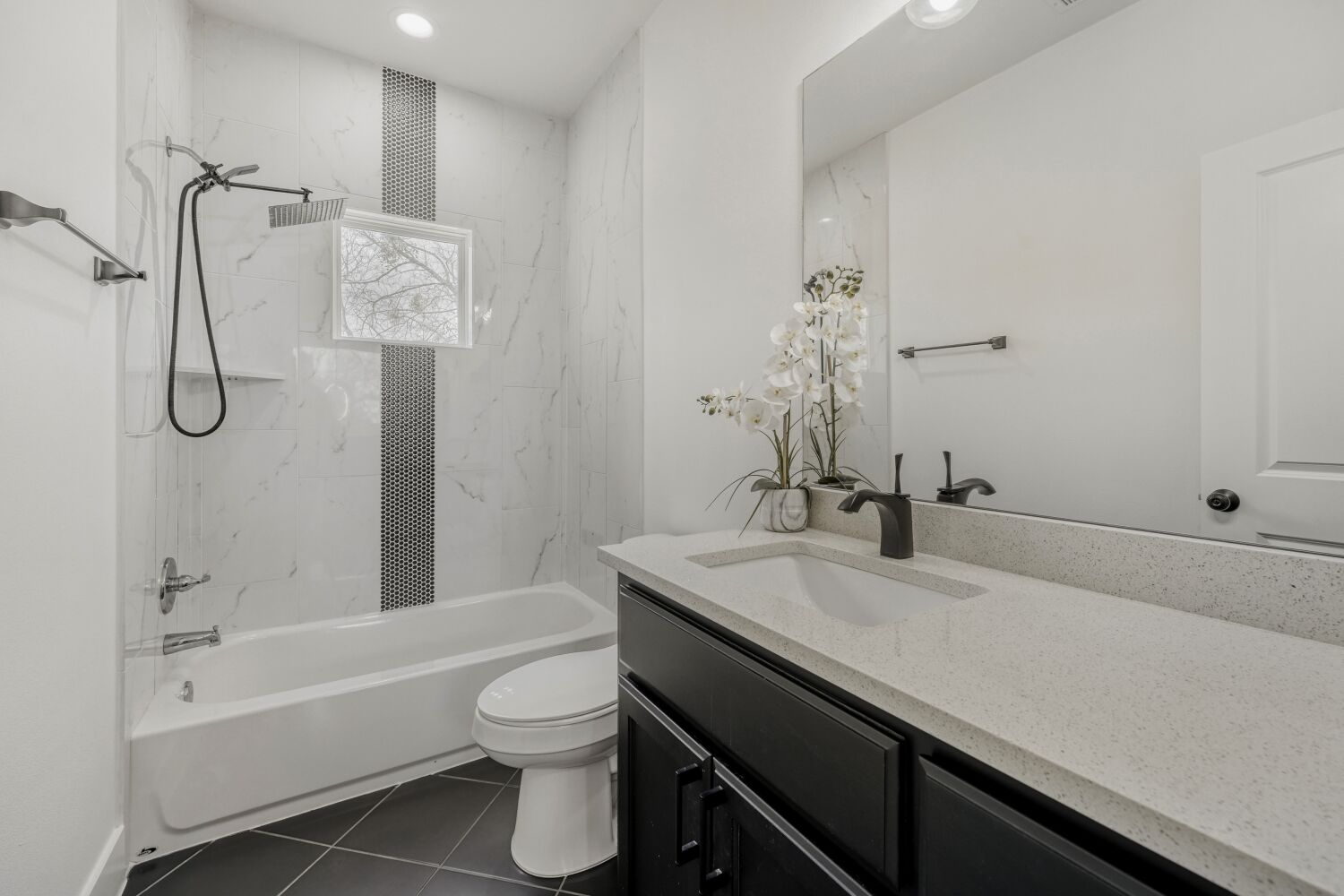 125 Irene Street Elgin, TX 78621 - Photo 16 of 24 Full bath with vanity, shower combination, and dark tile patterned flooring