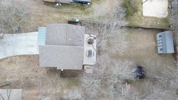 a view of a house with a yard and large tree