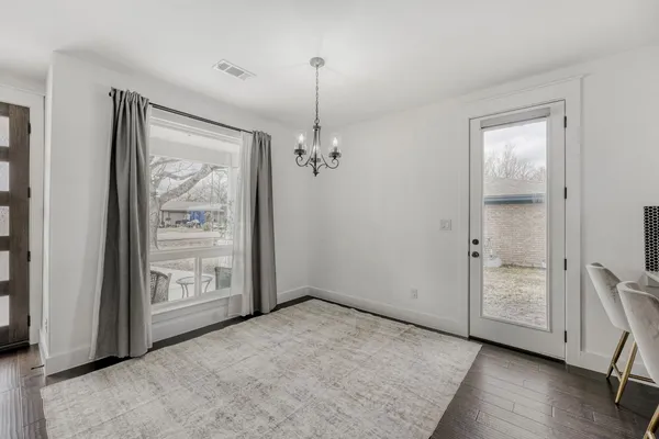 an empty room that has a wooden cupboard