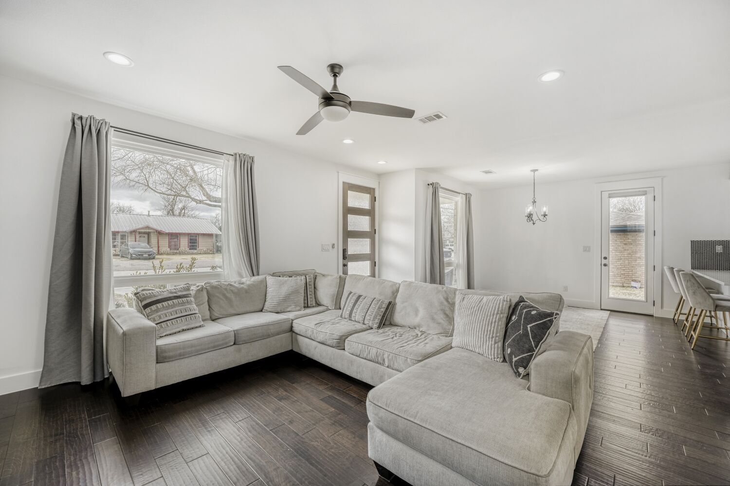 125 Irene Street Elgin, TX 78621 - Photo 8 of 24 Living area featuring suspended lighting, dark wood-style floors, and ceiling fan
