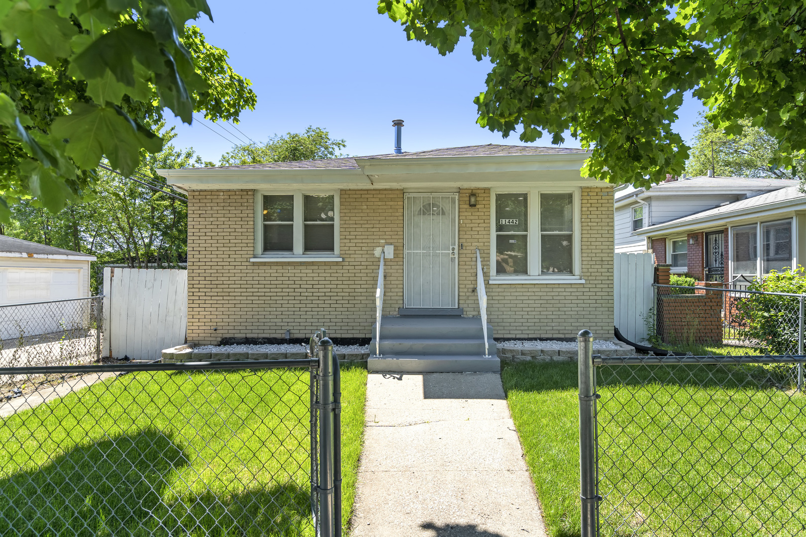 a front view of house with yard and green space