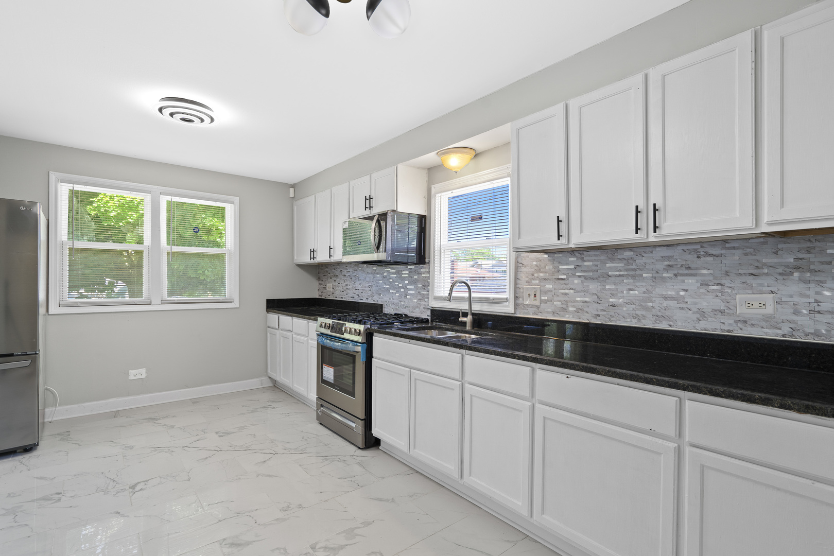 11442 South Aberdeen Street Chicago, IL 60643 - Photo 9 of 19 a kitchen with granite countertop white cabinets and a sink
