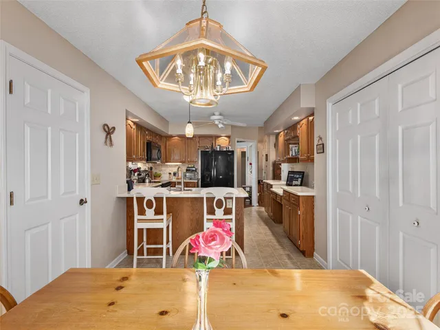 a kitchen with stainless steel appliances kitchen island granite countertop a stove and cabinets