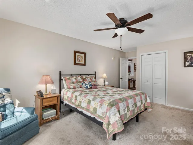 a bedroom with a bed and a ceiling fan