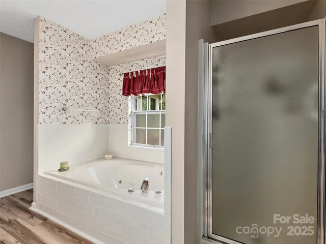 a bathroom with a bathtub and a shower