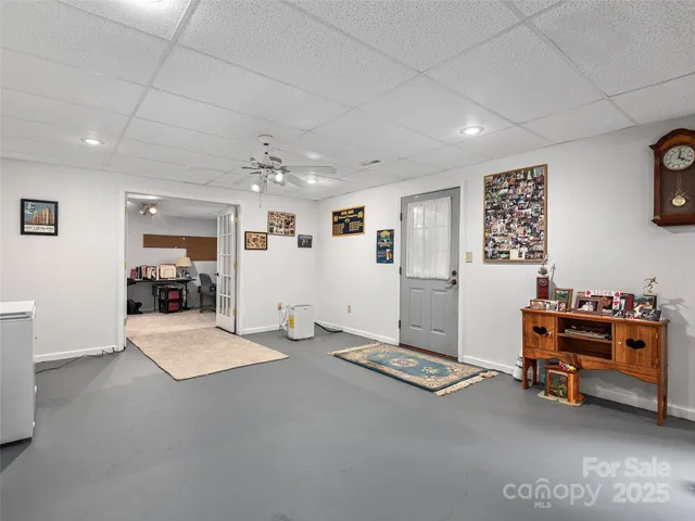 a living room with furniture and a pool table