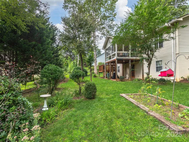 a view of house with yard and green space