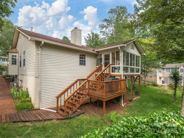 a view of a house with a yard and sitting area