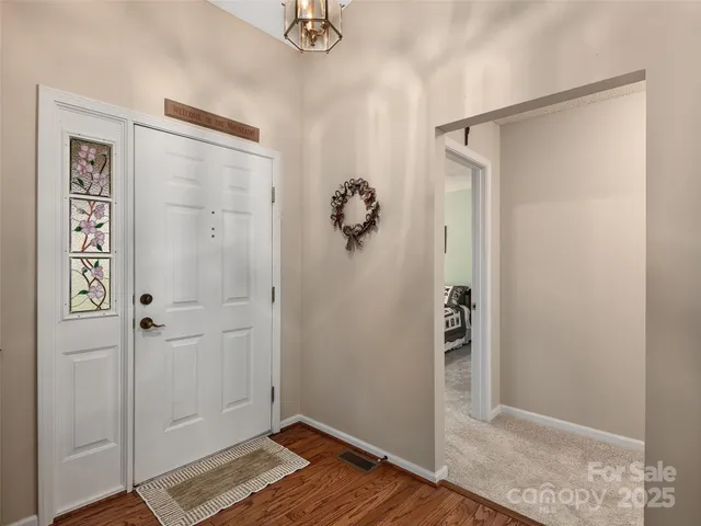 a view of walk in closet with wooden floor