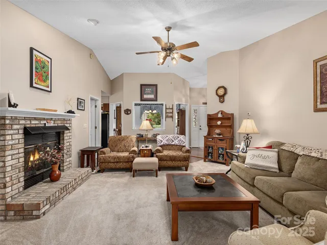 a living room with furniture a fireplace and a window