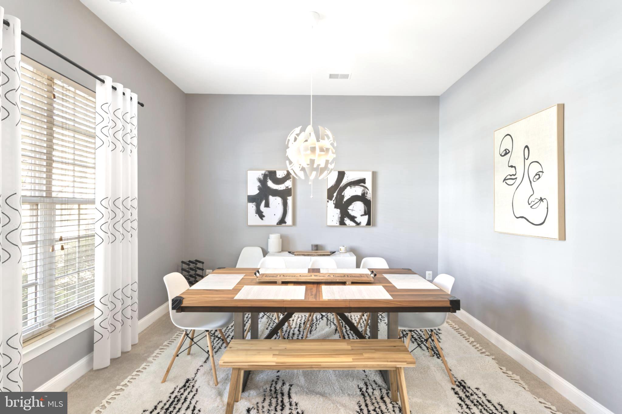 9152 Ribbon Falls Loop Bristow, VA 20136 - Photo 13 of 61 a dining room with a table and chairs