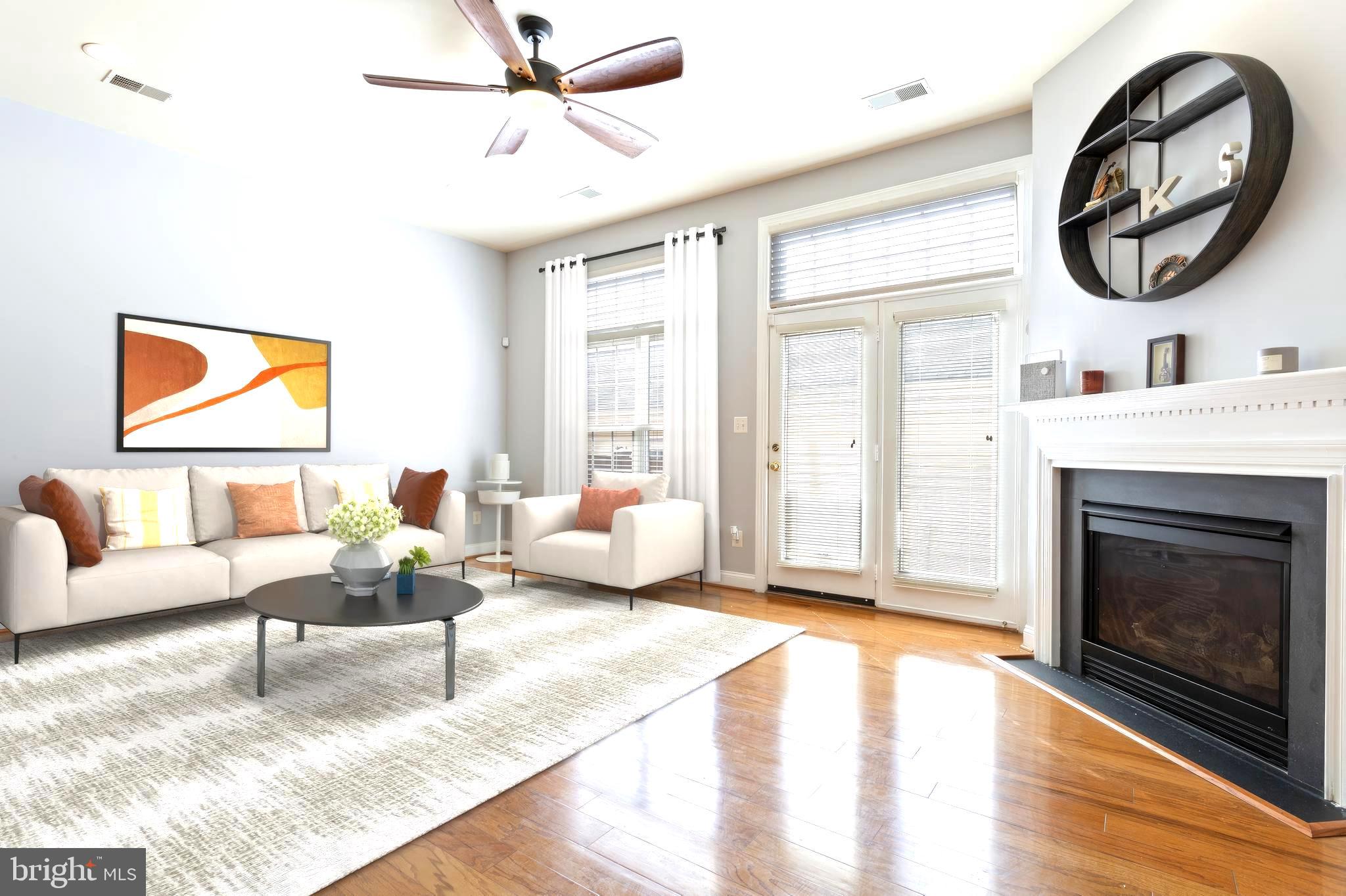 9152 Ribbon Falls Loop Bristow, VA 20136 - Photo 17 of 61 a living room with furniture a window and a fireplace