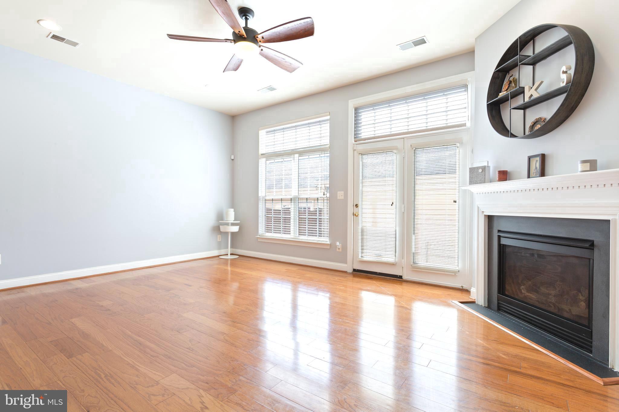9152 Ribbon Falls Loop Bristow, VA 20136 - Photo 18 of 61 a view of an empty room with a fireplace and a window
