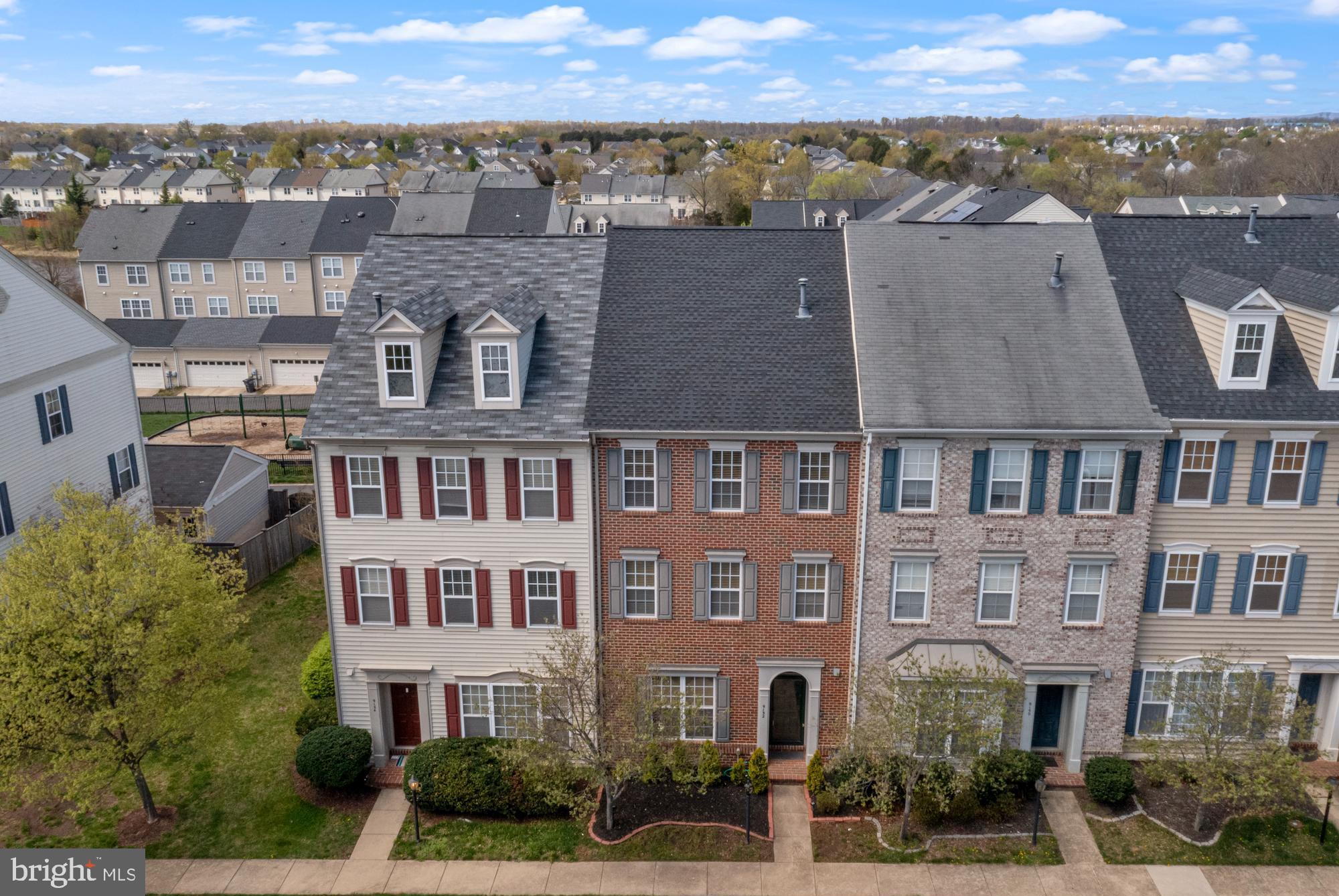 9152 Ribbon Falls Loop Bristow, VA 20136 - Photo 3 of 61 aerial view of a brick building next to a city view