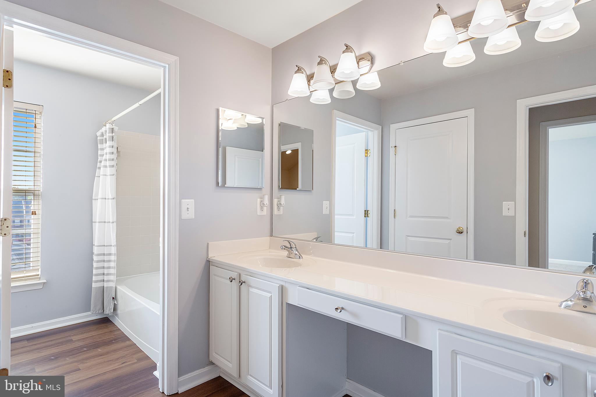 9152 Ribbon Falls Loop Bristow, VA 20136 - Photo 41 of 61 a bathroom with a double vanity sink and a mirror