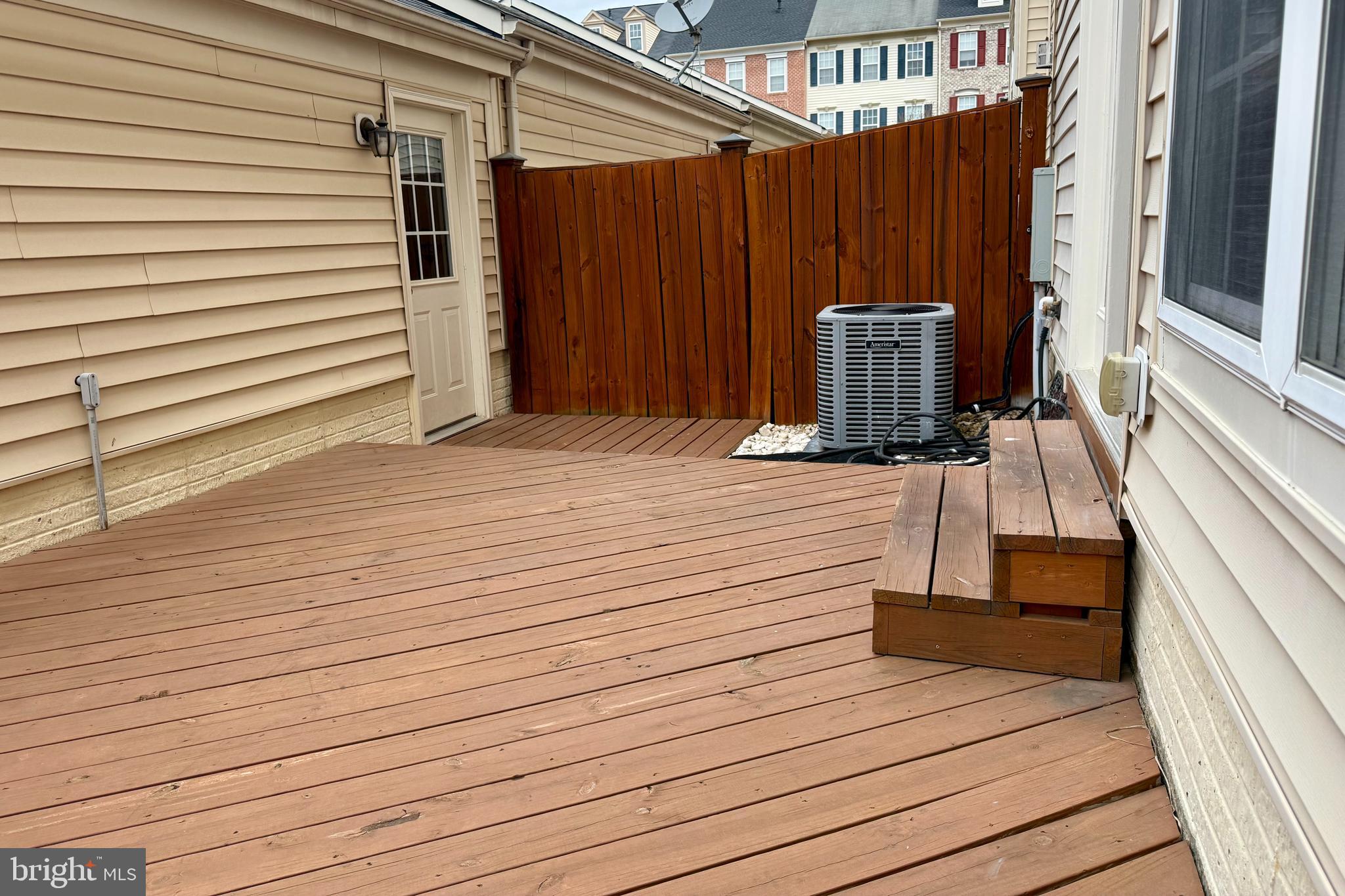 9152 Ribbon Falls Loop Bristow, VA 20136 - Photo 45 of 61 a view of a balcony with wooden floor and furniture