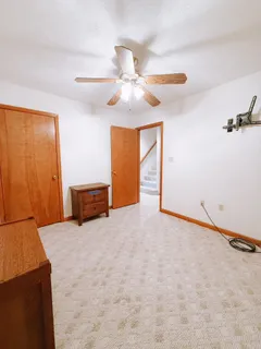 a bed room with furniture and chandelier