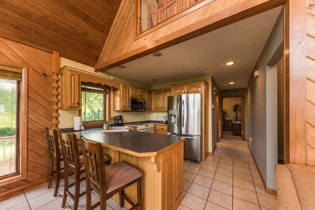 a view of hall way with furniture and fireplace