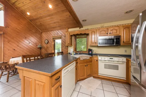a kitchen with a sink a counter top space cabinets and stainless steel appliances
