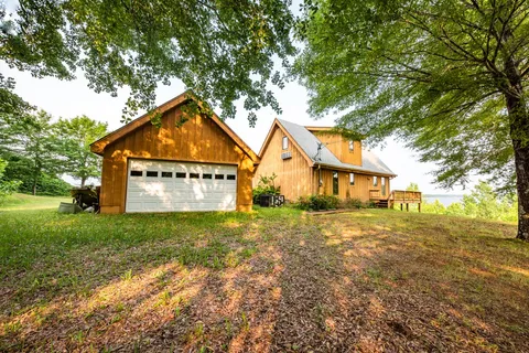 a house with huge green field in front of it