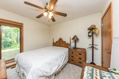 a living room with furniture and a floor to ceiling window