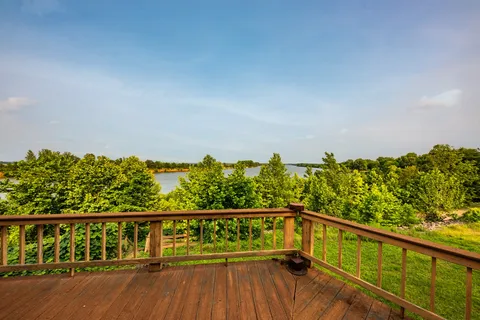 a front view of a house with a yard and trees