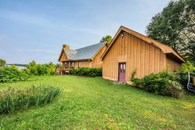 a view of a backyard with table and chairs and potted plants