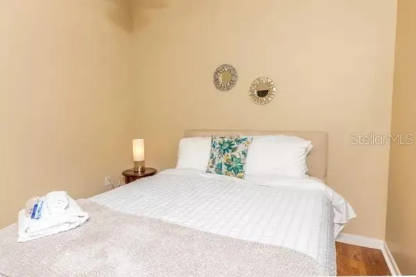 a bedroom with a bed and a night stand