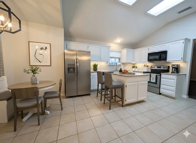 a kitchen with stainless steel appliances a refrigerator sink and cabinets