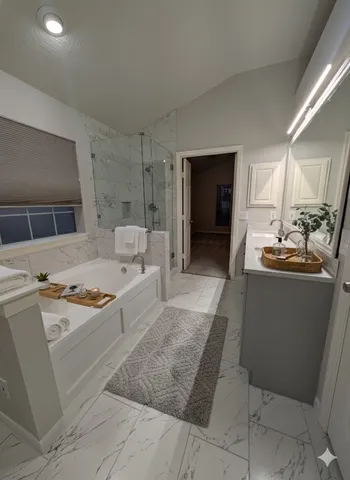 a large white kitchen with cabinets