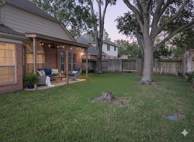 a backyard of a house with yard table and chairs