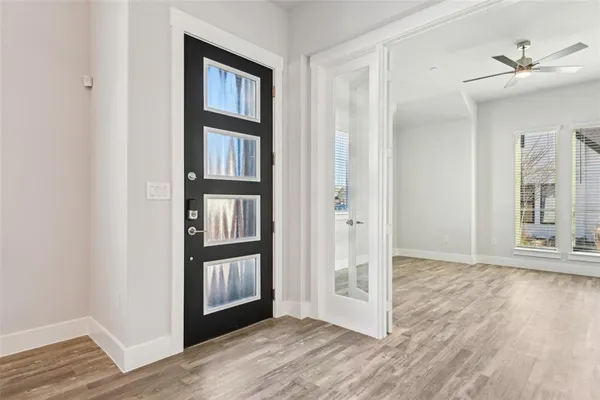 an empty room with wooden floor and a window