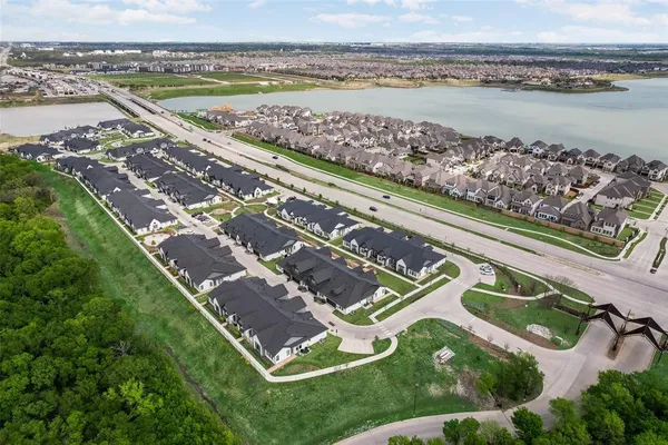a view of a lake with houses in the background