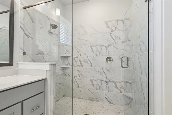 a bathroom with a double vanity sink and mirror