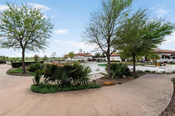a view of a street with a bench and trees