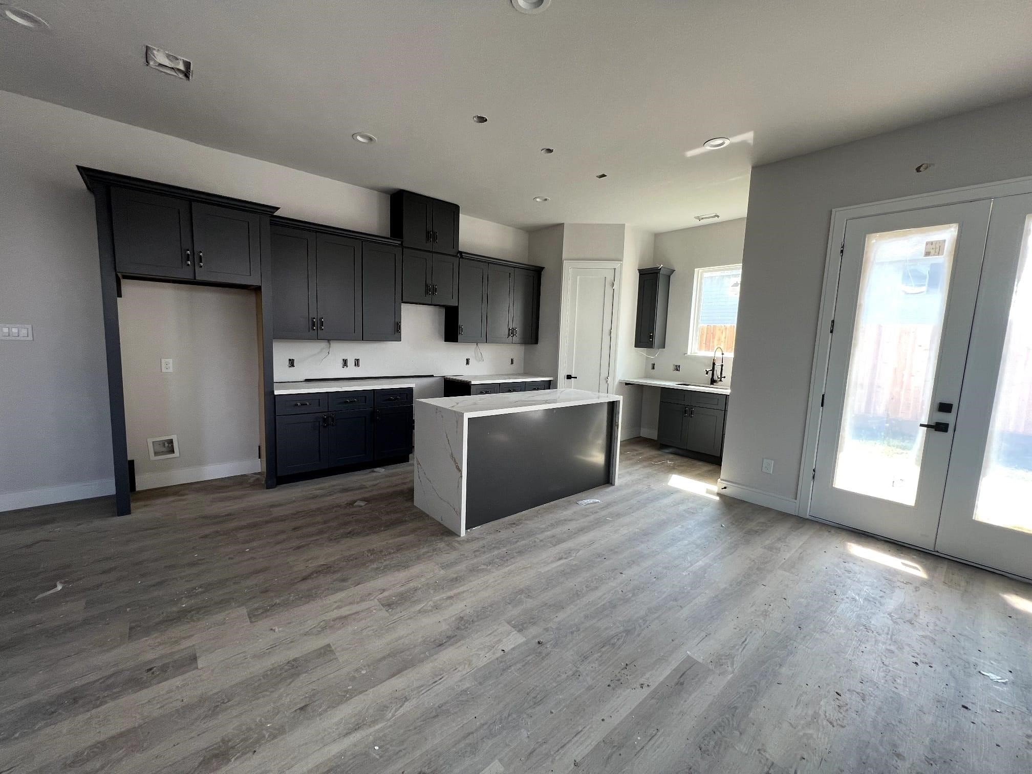 6407 Sidney Street Houston, TX 77021 - Photo 6 of 8 a kitchen with stainless steel appliances a stove top oven a sink and a refrigerator